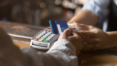 paying-with-a-card-female-hand-1440x810
