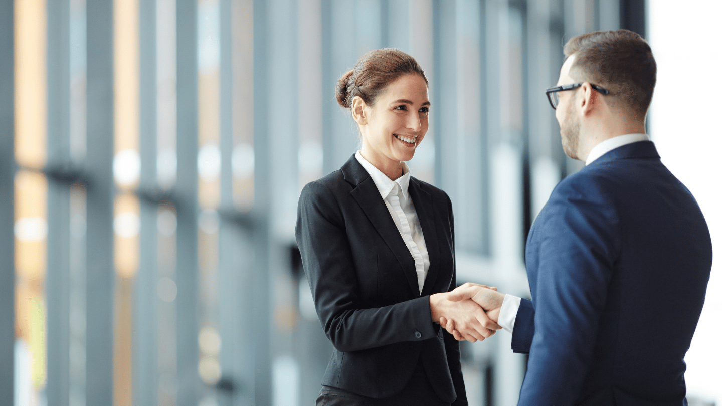 woman_suit_handshake_1440x810