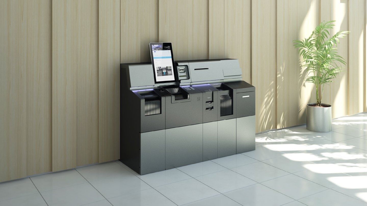 Imagem do TellerConcierge, com tela touchscreen, ideal para facilitar transações em ambientes comerciais. O design é elegante e funcional, com compartimentos e controles acessíveis.